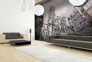 Soggiorno dalle tinte grige dove il punto focale e rappresentato dalla parete-tesa-stampata e dalle forme minimali del divano.